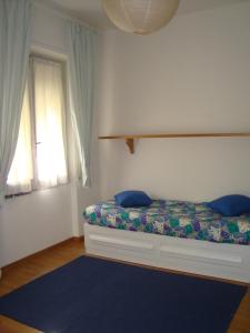 a bedroom with a bed with blue pillows and a window at Sotto Fiesole in Florence