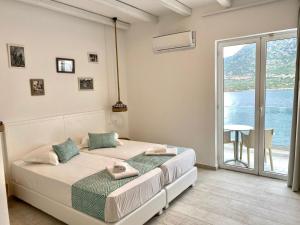 1 dormitorio con 2 camas y balcón en Blue Bay Lifestyle - ex Bali Blue Bay, en Balíon