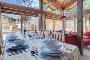 a dining room with a table with dishes on it at Chalet Madeleine in Morzine