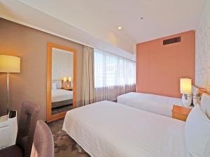 Postel nebo postele na pokoji v ubytování LOISIR HOTEL SHINAGAWA SEASIDE