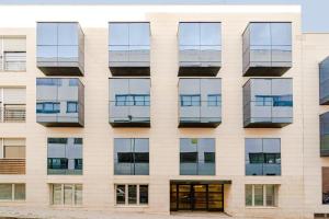an external view of a building with windows at Francisco Remiro Fabulous Furnished Apartments in Guindalera in Madrid