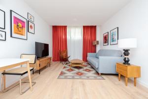 a living room with a couch and a tv at Francisco Remiro Fabulous Furnished Apartments in Guindalera in Madrid