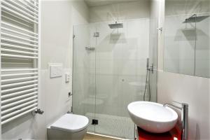 a bathroom with a toilet and a sink and a shower at Hotel Aurea in Rimini +69 photos