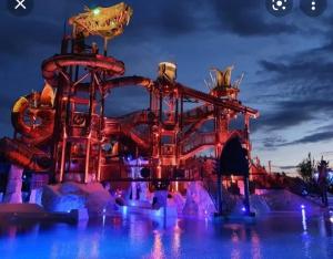 a water park at night with a roller coaster at Cosy chic in Erstein