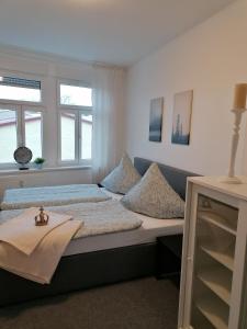 a bedroom with a bed with pillows on it at Apartment Bona Loca in Aschersleben