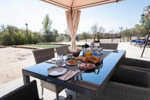 a blue table with food on it on a patio at El Toril Glamping Experience in Parrillas