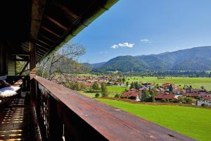 a view of a village from a wooden balcony at Haus Waldeck in Reit im Winkl