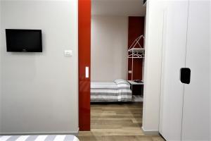 a hallway with a room with a bed and a television at Hotel Aurea in Rimini