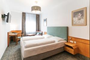 Ένα ή περισσότερα κρεβάτια σε δωμάτιο στο Altstadthotel Grauer Wolf