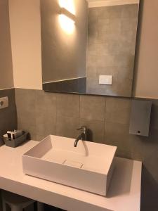 a white sink in a bathroom with a mirror at Venice Terminal Apartments & Suites in Mestre