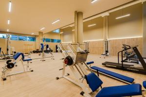 a gym with several treadmills and machines at Los Olivos Stylish Apartments in Conde Orgaz Area in Madrid