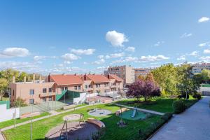 a park with a playground in a city at Las Encinas Design Apartment in Conde Orgaz Area - Madrid in Madrid
