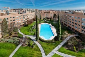 an overhead view of an apartment complex with a swimming pool at Los Castaños Design Apartments in Conde Orgaz Area in Madrid
