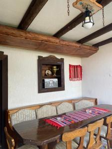 a dining room table with chairs and a wooden table at LIKE HOME in Râşnov