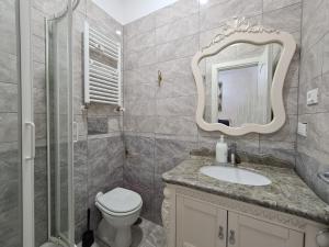 a bathroom with a toilet and a sink and a mirror at innstation guesthouse in Rome