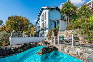 a house with a swimming pool in front of a house at CASA LUNA ALMA in Brione sopra Minusio