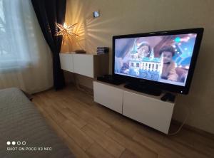 a flat screen tv sitting on a white entertainment center at Travel inn Kremlin in Velikiy Novgorod
