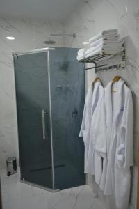 a shower in a bathroom with white towels at Гостиничный комплекс "Коктобе" in Aktobe