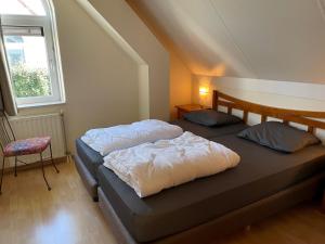 En eller flere senge i et værelse på Vakantiewoning Banjaard