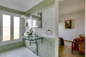 a bathroom with a shower with a glass counter at Hôtel du Square d'Anvers in Paris