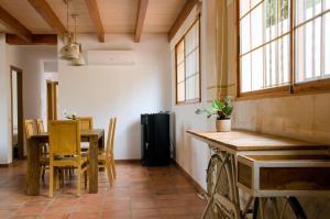a kitchen with a table and chairs and windows at Las Palmeras Playamonte in Navarrés +13 photos