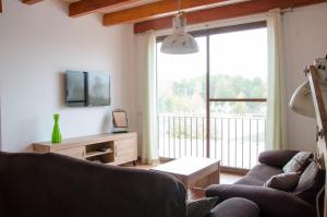 a living room with two couches and a large window at Las Palmeras Playamonte in Navarrés