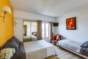 a hotel room with a bed and a mirror at Hôtel du Square d'Anvers in Paris
