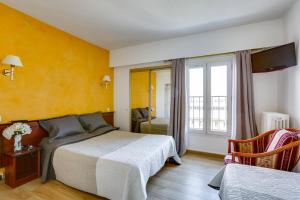 a hotel room with a bed and a window at Hôtel du Square d'Anvers in Paris