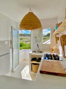 a kitchen with a sink and a stove top oven at Castell Sol - Arenal Den Castell in Arenal d'en Castell