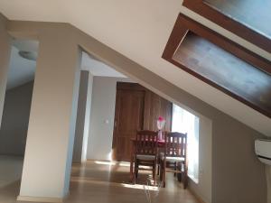 a room with a staircase with two chairs and a table at Mountain Sunrise in Bansko