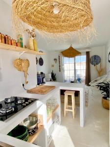 a kitchen with a counter and a stove top oven at Castell Sol - Arenal Den Castell in Arenal d'en Castell