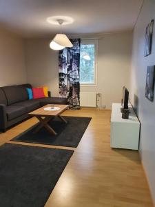 a living room with a couch and a table at Jääskän Loma Ratatie 3 asunto 7, Kauhava in Kauhava