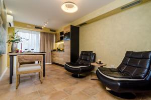 a living room with two chairs and a table at Apartment City Getaway in Dubrovnik