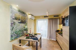 a kitchen with a table and a dining room at Apartment City Getaway in Dubrovnik