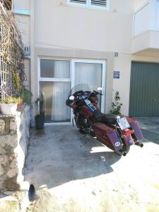 a red motorcycle parked in front of a building at Apartment City Getaway in Dubrovnik