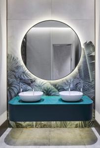 a bathroom with two sinks and a mirror at Lamartine Hotel in Istanbul