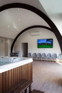 a large room with a large tub and chairs at HVT Comfort Apartments in Mezőkövesd +70 photos