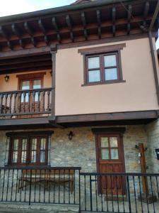 a house with a balcony on the side of it at El Balcon del Horreo in Piloña