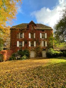 ein altes Backsteinhaus mitten im Hof in der Unterkunft Le Domaine de Moroges in Moroges