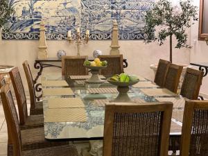 a dining room with a table with bowls of fruit on it at Grande villa d'exception en Normandie tennis, piscine, jacuzzi, salle de fitness in Muids
