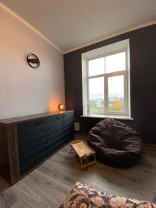 a bedroom with a bean bag chair and a large window at Quite center of Riga in Rīga
