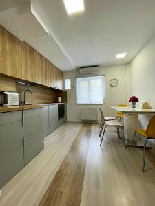 a kitchen and dining room with a table and chairs at Start Apartments 2 in Bucharest