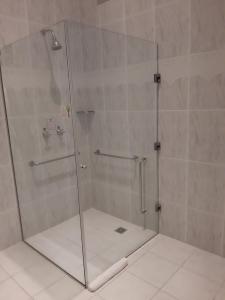 a bathroom with a shower stall with a glass door at Hotel San Juan Johnscher in Curitiba