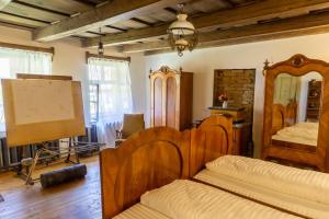 a bedroom with wooden furniture and a bed and a table at Șura din Seleuș - Seleuș Barn - Idyllic Countryside M Museum House in Sighişoara