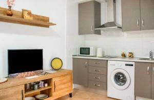 uma cozinha com uma máquina de lavar roupa e um micro-ondas em Bonito apartamento en Garrucha em Garrucha