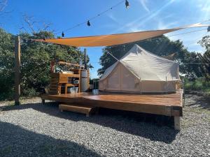 a tent sitting on top of a wooden ramp at Pitahaya Glamping in Cabo Rojo