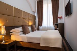 Postel nebo postele na pokoji v ubytování Albergo Rossini 1936