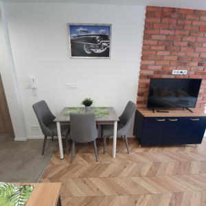 Telewizja i/lub zestaw kina domowego w obiekcie Ice Apartments