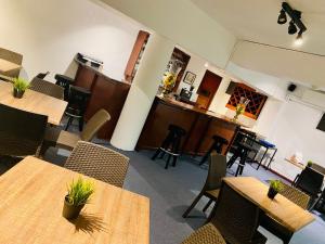 an empty restaurant with tables and chairs with plants on them at RIG Casa Conde in Santo Domingo +65 photos