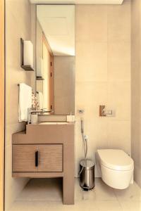 a bathroom with a toilet and a sink and a mirror at Luxury at The Address Jumeirah Beach Residence in Dubai